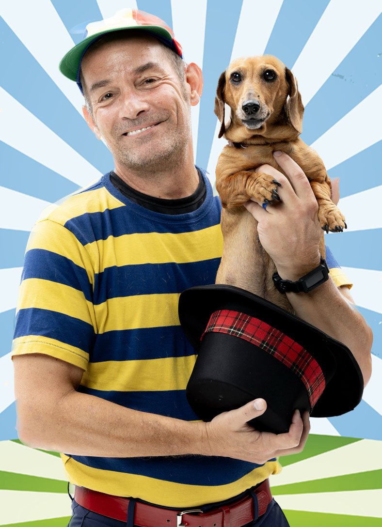 Mr. Twisty holding Penny the dachshund